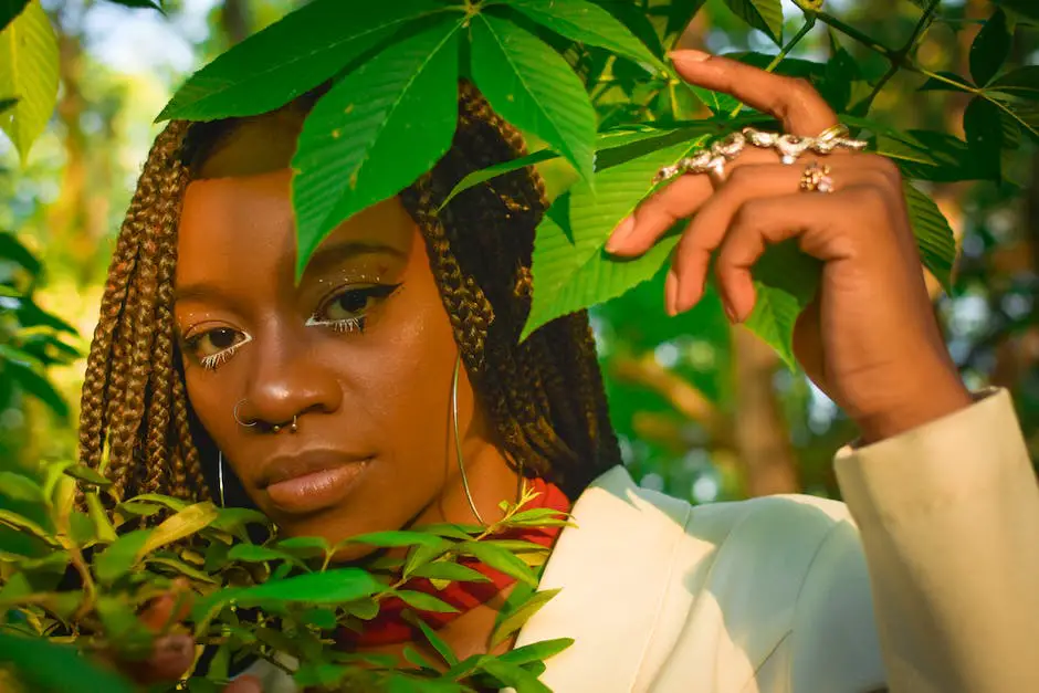 woman with braids standing between tree leaves with septum piecing