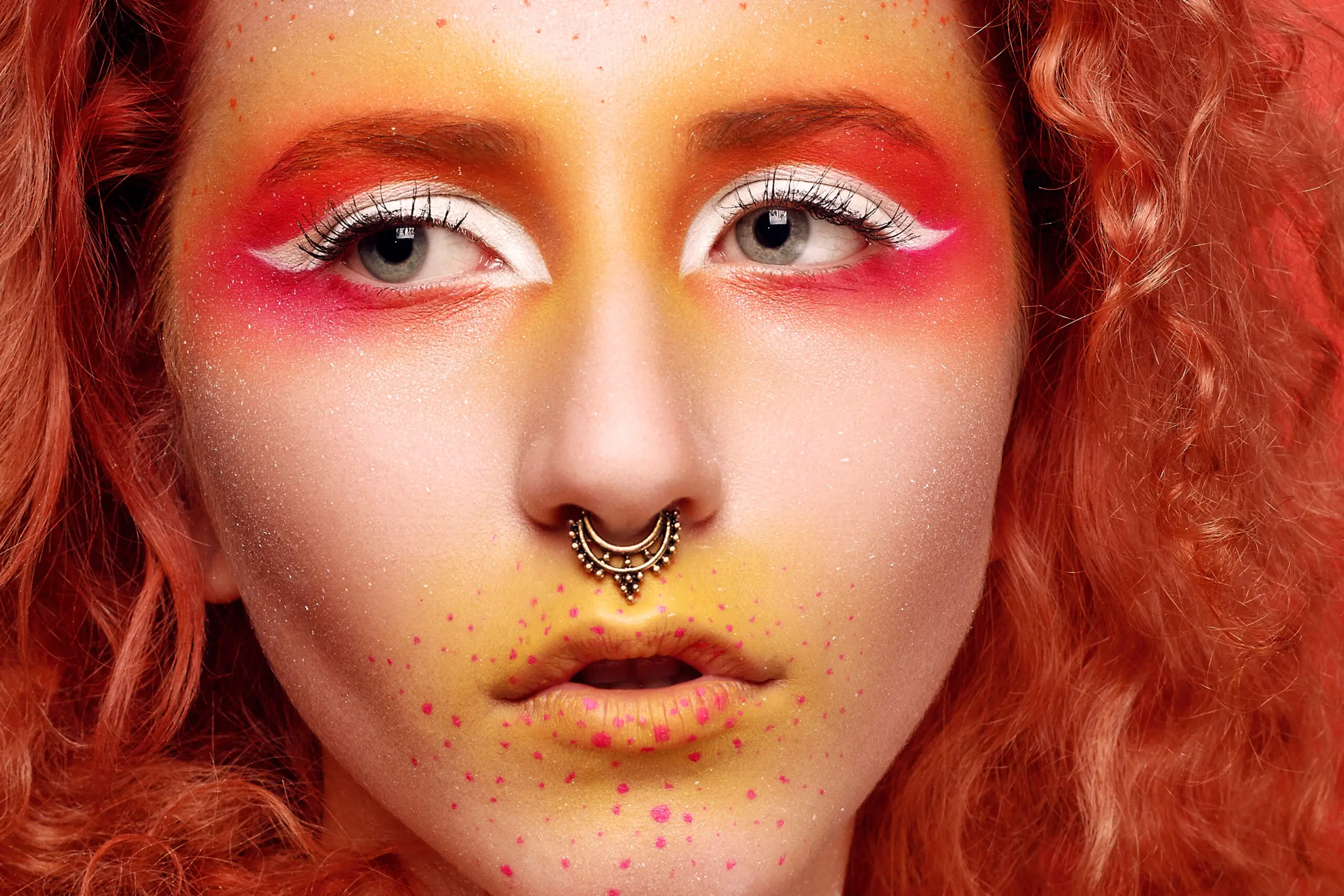 girl with septum piercings and red hair, artistic makeup portrait